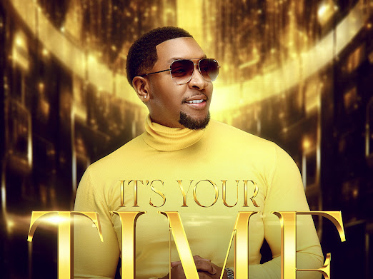 Reggie - It’s Your Time 1 Reggie Jenkins, a Christian music artist, holding a microphone and smiling, with a background of musical notes and inspirational quotes. The image represents Reggie's new single 'It's Your Time' and his upcoming EP project